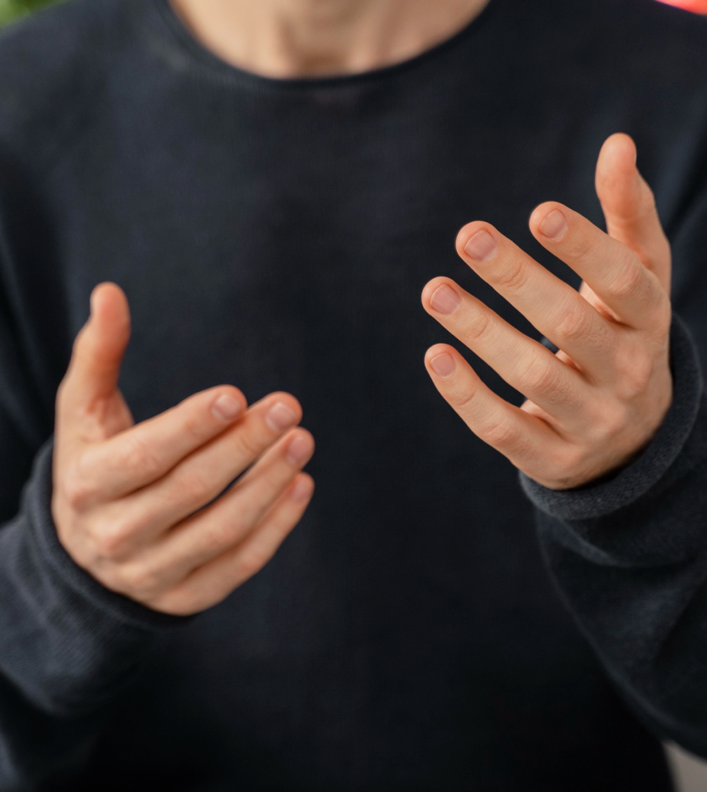 Person talking with their hands out in front of them as they explain what they are going through to admissions at Able to Change Recovery