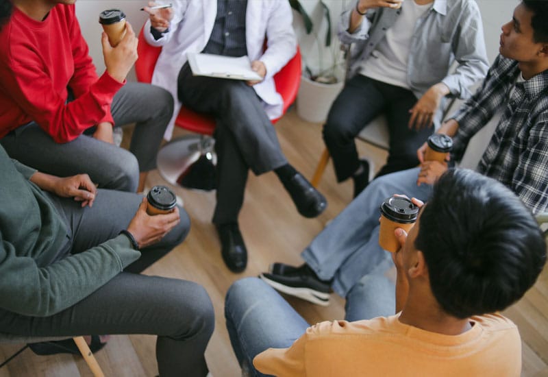 People sitting in a circle discussing something together