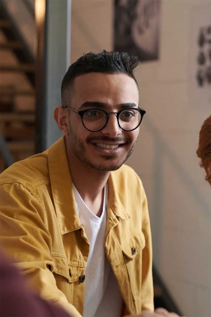 Man smiling and talking to his therapist during therapy