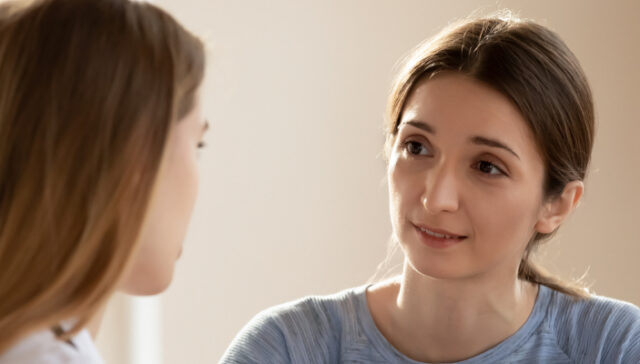 Person reviewing insurance documents with an advisor while choosing a rehab that takes their insurance