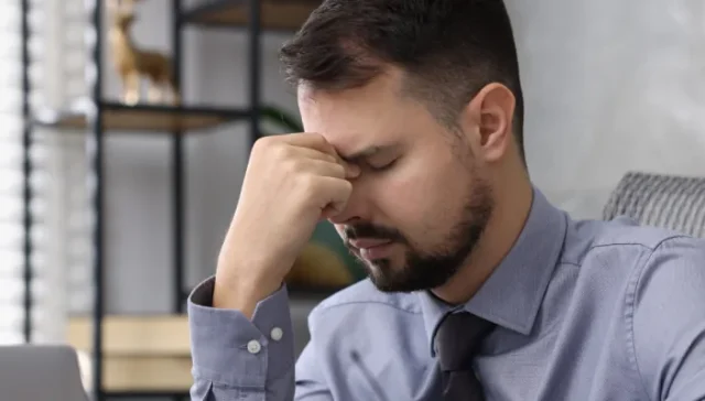 Working adult tired after not reviewing a PHP schedule and FMLA paperwork while balancing job responsibilities with treament